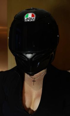 a woman wearing a black shirt and helmet