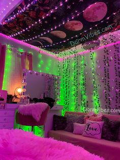 a room decorated in pink and green with lots of lights on the ceiling, couches and other decorations