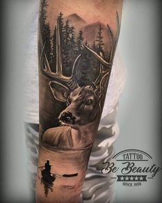 a man's arm with a deer and boat in the water tattoo on it