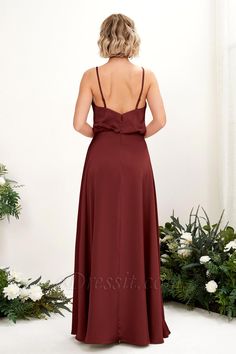 the back of a bridesmaid's dress with straps on it and flowers in the background