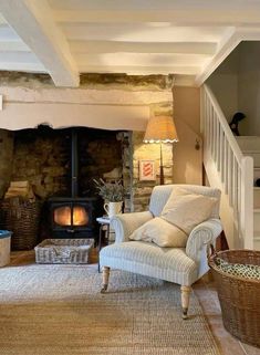 a living room filled with furniture and a fire place next to a wooden burning stove