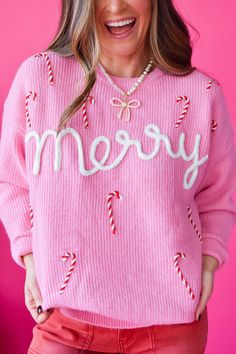 Stay cozy and stunning this holiday season with our Candi Sweater! In a blush pink hue with a playful "merry" candy cane detail, this relaxed fit crewneck exudes Christmas spirit in a unique and trendy way. Perfect for adding a touch of charm to your winter wardrobe. Product Details: measurements: BUST: small 22.5" medium 23" large 24" 56% acrylic, 27% nylon, 17% lycry super soft and cozy blush pink sweater with white lettering, red and white candy canes relaxed fit model wearing size small mode Candy Cane Outfit Ideas, Pretty Christmas Sweaters For Women, Xmas Sweater Outfit, Christmas Clothes Women, Pink Christmas Outfits Women, Candy Cane Outfit, Ugly Christmas Sweaters Diy, Candy Cane Sweater, Cute Christmas Sweaters