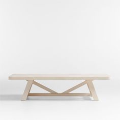 a wooden bench sitting on top of a white floor