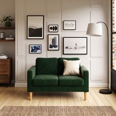 a living room with green couches and pictures on the wall