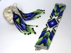 two pieces of beaded bracelets sitting next to each other on a white surface