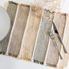 a plate and fork sitting on top of a place mat