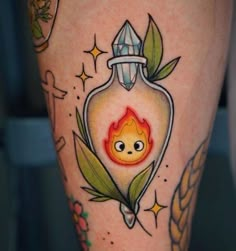 a tattoo on the leg of a woman with a fire in a bottle and leaves