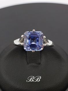 Made to order.  Please allow up to 3 weeks for production of your ring. This listing is for a 925 unplated sterling silver ring with a high quality lab created ceylon blue sapphire gemstone. Gem Type: Lab Created Sapphire Shape: Asscher Cut Size: 8mm Weight: 2.5 carats approximately Quality: AAA Hardness: 9 Mohs Available in the following Metal Options (all are unplated metals) 925 Sterling Silver 10kt White Gold (non-rhodium plated) 10kt Yellow Gold 14kt White Gold (non-rhodium plated) 14kt Yellow Gold 14kt Rose Gold Did you know lab-created sapphires are equivalent to natural sapphires? Lab grown sapphires have the same chemical composition as natural sapphires. They have the same refractive index (sparkle), specific gravity etc. They are made of corundum, the same thing mother nature ma Tanzanite Asscher Cut Ring With Prong Setting, Octagon Sapphire Ring In Sterling Silver For Anniversary, White Gold Sterling Silver Sapphire Octagon Ring, Blue Asscher Cut Sterling Silver Jewelry, Octagon Sterling Silver Ring For Formal Occasions, Classic Octagon Sapphire Ring In Sterling Silver, Classic Tanzanite Jewelry For Promise Ring, Asscher Cut Tanzanite Fine Jewelry, Polished Tanzanite Jewelry For Anniversary