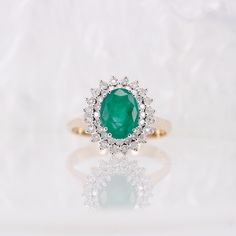 9ct Gold Natural Emerald & Diamond Ring,Vintage,9KYellow Gold,Oval Cut,Engagement Ring,Dress Ring,Anniversary Gift,Size UK M US 6.25 EUR 52.5 Evelyn is a stunning emerald and diamond ring set in 9ct gold. Her gorgeously rich green oval cut emerald has superb tone and unique crystal inclusions partnered with a double halo of diamonds with excellent sparkle.  Hallmark: UK Hallmark375 Emerald: x1 Oval Cut 1.75ct Total Estimated Carat Weight  Diamonds: Double halo 0.22ct total  Weight: 3.7g Size: UK M US: 6.25  EUR: 52.5 Ring head measures 7.5mm X 9x5mm PLEASE NOTE Any variation on the ring size listed will take an additional 10-14 for dispatch whilst the ring size is adjusted with our workshop. We can size your chosen ring if required but please message us prior to ordering so we can advise f Classic Yellow Gold Emerald Ring With Halo, Gold Emerald Oval Cabochon Ring For Wedding, Oval Yellow Gold Emerald Ring With Halo, Gold Oval Cabochon Emerald Wedding Ring, Gold Emerald Wedding Ring With Oval Cabochon, Classic Yellow Gold Emerald Ring With Halo Setting, Oval Gold Emerald Ring With Halo Setting, Oval Emerald Ring In Yellow Gold With Halo Setting, Yellow Gold Oval Halo Ring With Center Stone