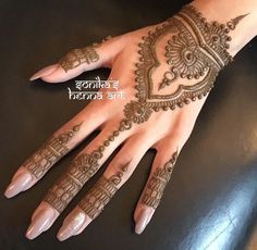 the hand is decorated with henna on it