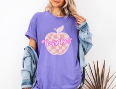 Super cute Barbie back to school teacher t shirt. This comfort colors graphic tee will be a fun way to elevate a cute outfit! You could gift this to someone or grab it for yourself! Sizing: Sizes range from an S-4XL in 6 colors. Shipping: It should take about 2 weeks for your order to arrive at your door. 1-7 business days for processing and 1-10 days for it to be shipped! Returns: I do not accept returns or exchanges so please make sure the size and color is correct before ordering. However, if there is an issue with your order when you receive it, please feel free to reach out to see if we can resolve the problem! Comfort Colors introduces the "Comfort Colors 1717" garment-dyed t-shirt; a fully customizable tee made 100% with ring-spun cotton. The soft-washed, garment-dyed fabric brings Casual Relaxed Fit T-shirt For Back To School, Trendy School T-shirt With Crew Neck, Casual T-shirt With Text Print For Back To School, Casual Back To School T-shirt With Funny Print, Casual Back-to-school T-shirt With Funny Print, School Spirit T-shirt With Funny Print, Casual Funny Print T-shirt For Back To School, Casual T-shirt With Funny Print For Back To School, Purple School Spirit T-shirt With Graphic Print