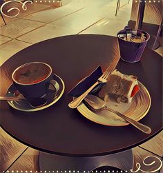 a table with a plate, fork and knife on it next to a cup of coffee