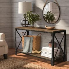 a living room with a couch, table and mirror on the wall next to it