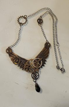 18 inch Brass Steampunk Winged Necklace, Costume Jewelry, Fashion Accessory with Clock Gears This is wonderful find with no visible flaws.  It measures 18 inches in diameter and the pendant is an additional 1.25 inches long.  We have a variety of items for every taste. Combine several of our items together to save on shipping. If you have any questions, please do not hesitate to ask. I also ship internationally. Happy Shopping.  As shop owners we will do our best to describe any issues or problems with our items. Since we do sell vintage and antiques there may be some flaws. Please check out the pictures very carefully and feel free to ask any questions. All sales are final. With any glass items, we price the item to be shipped as soon as reasonably possible with $100 insurance (if the ite Steampunk Wings, Clock Gears, Assemblage Jewelry, Wing Necklace, Steampunk Jewelry, Costume Jewelry, Halloween Shopping, Jewelry Necklace Pendant, Happy Shopping