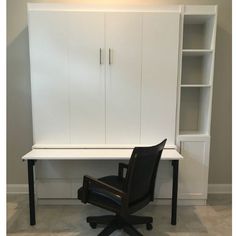 an office chair sitting in front of a white cabinet