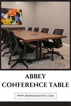 a conference table with black chairs in an office