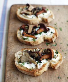 three pieces of bread topped with mushrooms and cheese