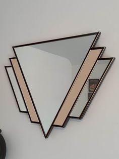 a mirror that is hanging on the wall next to a clock with a reflection in it