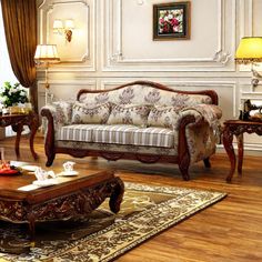 a living room filled with furniture on top of a hard wood floor covered in rugs