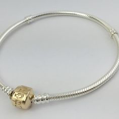 Authentic Pandora Sterling Silver & 14k Gold Snap Clasp Bracelet Elegant Two-Tone Bracelet With 14k Gold Clasp Length - 7.9" This Bracelet Has The Crown Over The O. Brand New And Unused! Retail Price: $325 Brand New! Absolutely Guaranteed Authentic. My Beads Were All Purchased From Jewelers Who Needed To Liquidate Their Inventory And Were Authorized Retailers Of The Product Line. Classic White Gold Charm Bracelet With Sterling Silver Clasp, Classic White Gold Charm Bracelet With Silver Clasp, Luxury Gold Sterling Silver Charm Bracelet, Anniversary Snake Chain Jewelry In White Gold, White Gold Snake Chain Jewelry For Anniversary, Anniversary White Gold Snake Chain Jewelry, Elegant Sterling Silver Charms Bracelet For Everyday, Gold Bracelet With Sterling Silver Clasp For Everyday, Gold Bracelets With Sterling Silver Clasp For Everyday