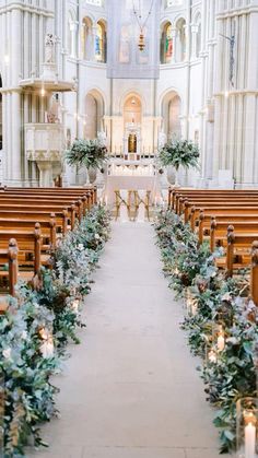 the aisle is decorated with greenery and candles for an outdoor wedding ceremony at st patrick's cathedral