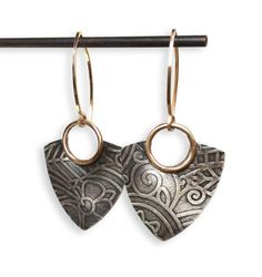 Our silver and gold fill Della earrings are sleek and modern, a perfect compliment to any outfit! We emboss the pattern on each individual earring, ensuring no two are identical! Other patterns are available; convo us for details. Made entirely from sterling silver that we oxidize and selectively polish to bring out the pattern. Finished with handmade 14K goldfill earwires; great for sensitive ears! Dimensions: Length of entire earring, including ear wire: 1 3/4"Width: 1" ★ See more from Queens Modern Etched Gold Jewelry, Modern Sterling Silver Etched Jewelry, Modern Etched Sterling Silver Jewelry, Gold Etched Drop Earrings, Sterling Silver Etched Gold Earrings, Elegant Etched Metal Earrings, Elegant Etched Dangle Jewelry, Gold Etched Sterling Silver Earrings, Etched Brass Earrings