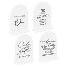 four white acrylic signs with black writing on them