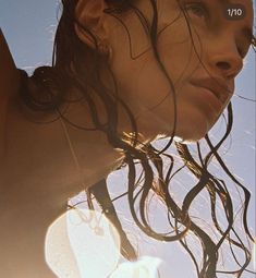 a woman with wet hair standing in the sun