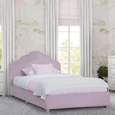 a bedroom with pink and white furniture and wallpaper