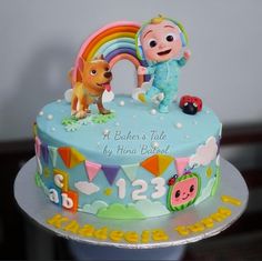 a baby's tale birthday cake with an image of a dog and a rainbow