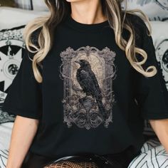 Introducing our gothic raven tee on our most comfortable and best selling shirt, Comfort Colors, available in an array of nature-inspired colors. Ravens are rich with symbolic significance, embodying intelligence, wisdom, and a hint of mystery across cultures. In Norse mythology, they are messengers of Odin, the god of wisdom, while in Native American lore, they are seen as shape-shifters bridging the mortal and spiritual realms. Often associated with change and transformation, the glossy black Dark Academia Goblincore, Gothic Raven, God Of Wisdom, God's Wisdom, Norse Mythology, Ravens, Dark Academia, Shirt Price, Tshirt Colors