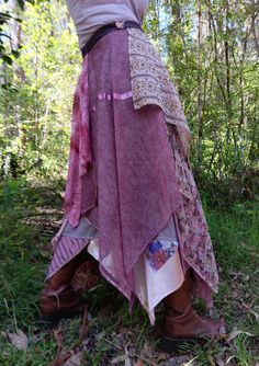 This pink and mushroom, multi-layered wrap skirt features patterned and ornamented silk, polyester, satin, rayon, jersey and silk on a polyester lining. Ornamental embellishments are also incorporated. The garment particularly suits day and evening wear celebrations and festivals. The skirt fits sizes 8 to 18. The length from waist band to longest fabric drop is approximately 105cm. Owing to its length the skirt is best worn with boots so as to give better ground clearance. Garment fastening and Bohemian Fitted Silk Skirt, Bohemian Silk Wrap Skirt For Summer, Bohemian Pink Wrap Skirt For Summer, Bohemian Handkerchief Hem Skirt, Bohemian Pink Dress With Lined Skirt, Fabric Skirt, Elf Costume, Des Roses, Scrap Fabric