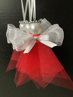 a red and white ornament hanging from a string