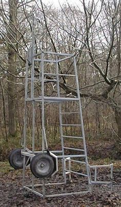 a metal ladder sitting in the middle of a forest