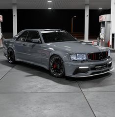 a silver car parked in front of a gas station