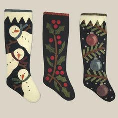 three christmas stockings with snowmen and pine cones on them, all decorated in different colors