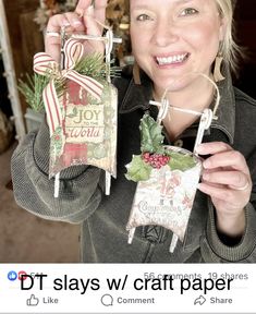 a woman is holding up some christmas cards