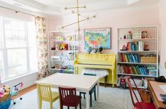 a child's room with a yellow piano and bookshelf in the corner