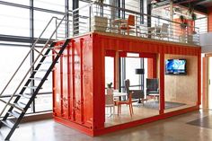 a living room with red shipping containers in it