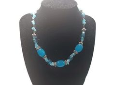 This necklace has medium blue beads and smaller light blue beads, It measures 16 inches long by .5 inches wide, The beads are glass. The blue will take your breath away! The beads are glass. Blue Round Beaded Glass Crystal Necklace, Blue Crystal Necklaces With Round Glass Beads, Blue Glass Crystal Necklace With Round Beads, Turquoise Glass Necklaces With Gemstone Beads, Blue Necklaces With Adjustable Oval Beads, Blue Oval Beads Necklace With Beaded Chain, Blue Beaded Crystal Necklaces With Round Beads, Blue Beaded Czech Glass Necklaces, Blue Beaded Crystal Necklace With Round Beads