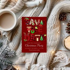 a red christmas party card sitting on top of a table next to a cup of coffee