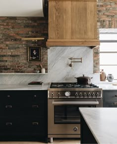 a stove top oven sitting inside of a kitchen next to an oven and countertop