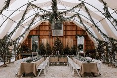 the inside of a tent with tables and chairs set up for an outdoor wedding reception