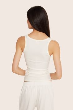 Stay stylish and comfortable with the Ribbed Modal Body Tank in Blanc. This fitted full-length tank top features a rounded square front neckline and full coverage back, crafted from luxurious ribbed modal fabric. Ribbed Fitted Tank Top With Scoop Neck, Ribbed Fitted Scoop Neck Tank Top, Fitted Ribbed Camisole With Scoop Neck, Fitted Modal Scoop Neck Camisole, Seamless Modal Tank Top, Fitted Modal Camisole Tank Top, Fitted Ribbed Modal Tops, Summer Ribbed Modal Tops, Fitted Solid Ribbed Tank Top