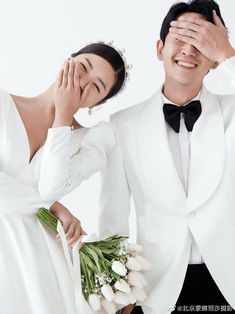 a man and woman in formal wear posing for the camera with their hands on their foreheads