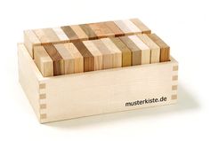 a wooden box filled with lots of different colored wood blocks on top of each other