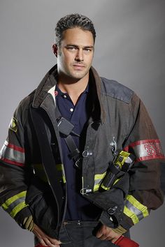 a man in a fireman's uniform is posing for the camera