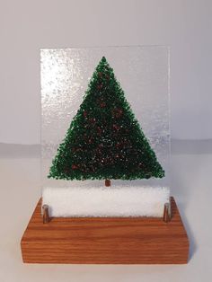 a snow globe with a christmas tree in it