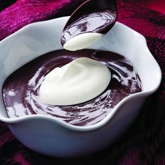 a spoon scooping chocolate into a white bowl