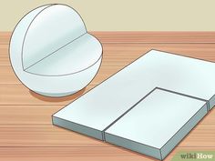 an open box sitting on top of a wooden table next to a white paper ball